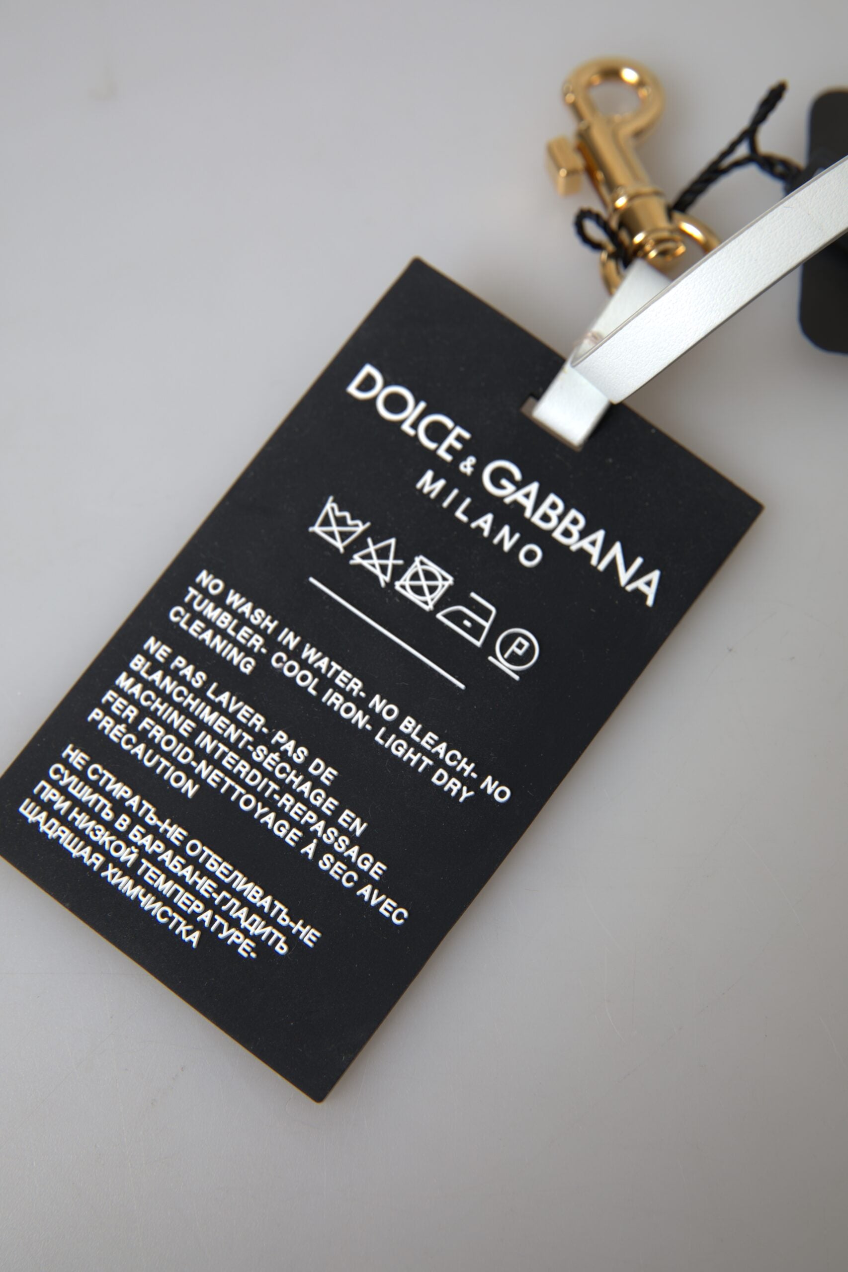 Portachiavi Dolce & Gabbana in ottone dorato con logo DG in silicone nero