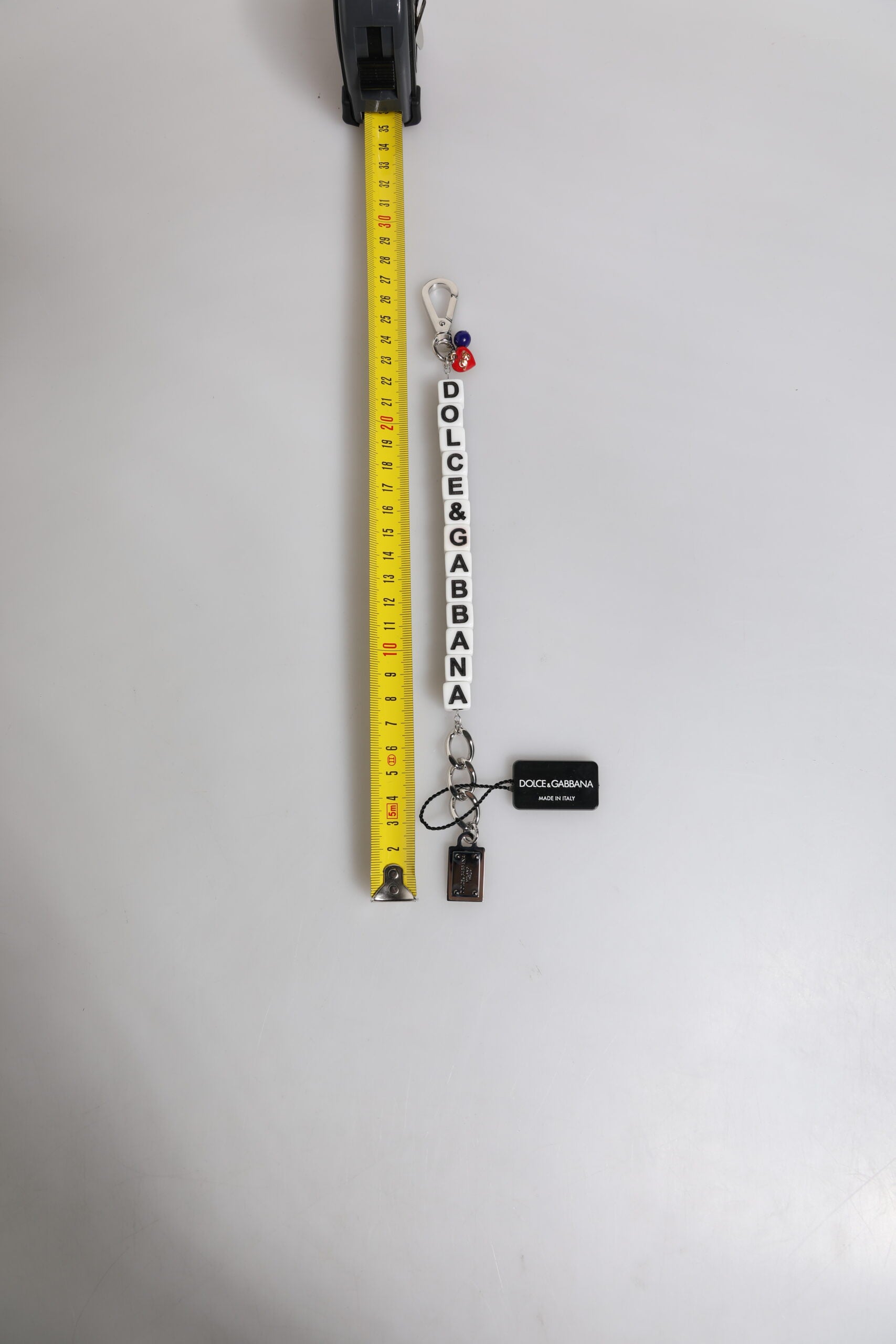 Bracciale Dolce & Gabbana con ciondolo a forma di dado in ottone color argento e logo