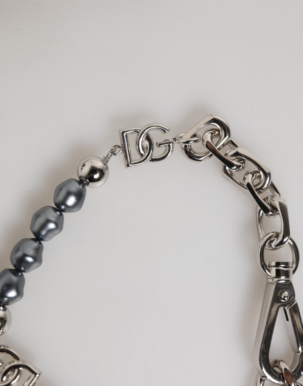 Bracciale Dolce & Gabbana con catena color argento, chiusura a moschettone, logo e perle grigie